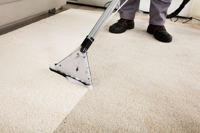 Carpet cleaning technician performing hot water extraction on residential carpet in Manor, TX